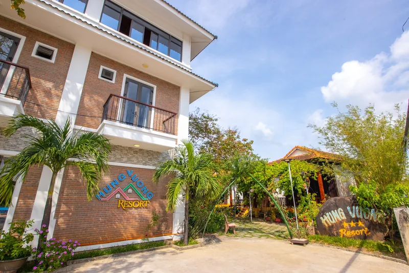 Two-storey blocks and bungalows set among palms