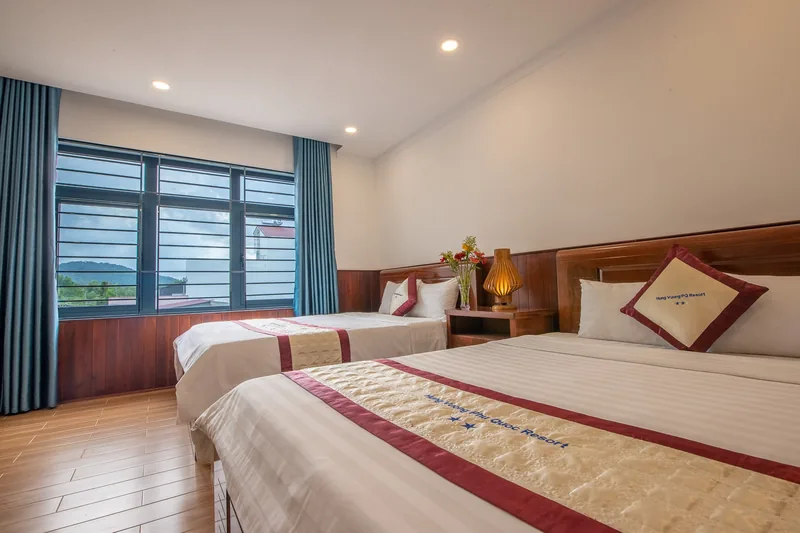 Family room with two beds and a window to the garden
