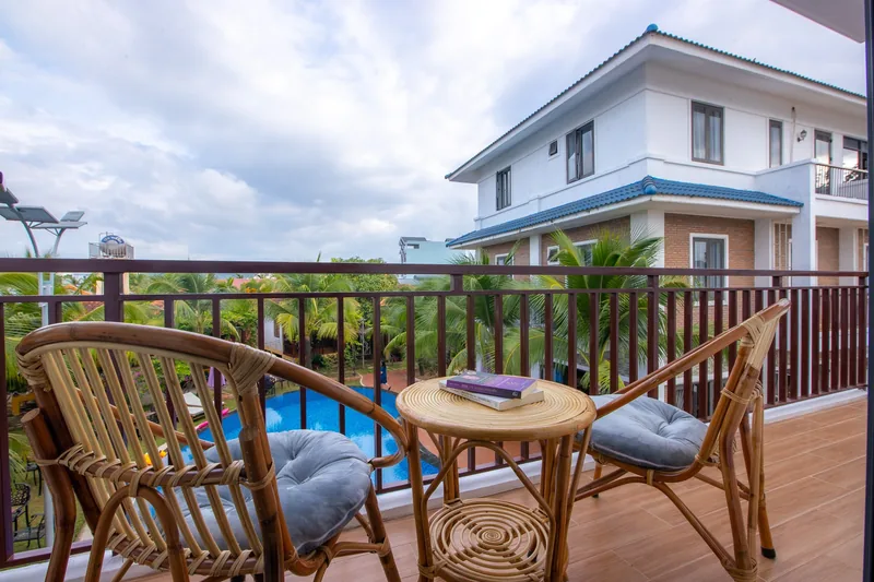 Balcony with rattan chairs over the pool