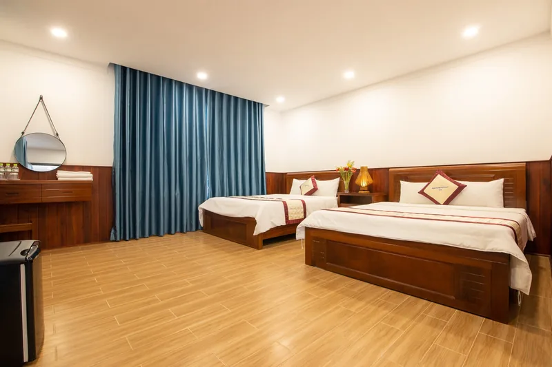 Deluxe Family Pool View room with two queen beds and blue curtains
