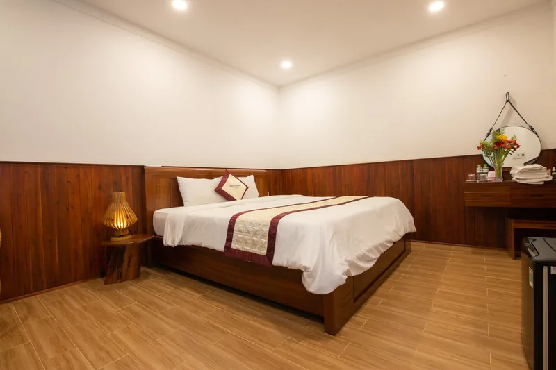 Deluxe Standard room in Block C with a double bed and wood-panelled walls
