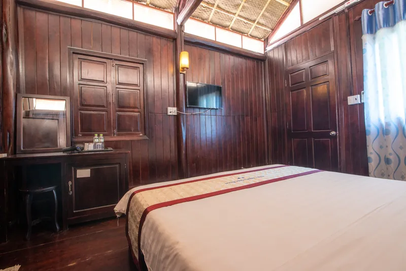Polished wooden walls, wardrobe and TV inside the bungalow